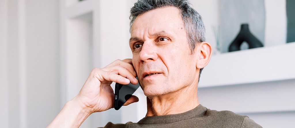 Concerned man on phone to medical professional